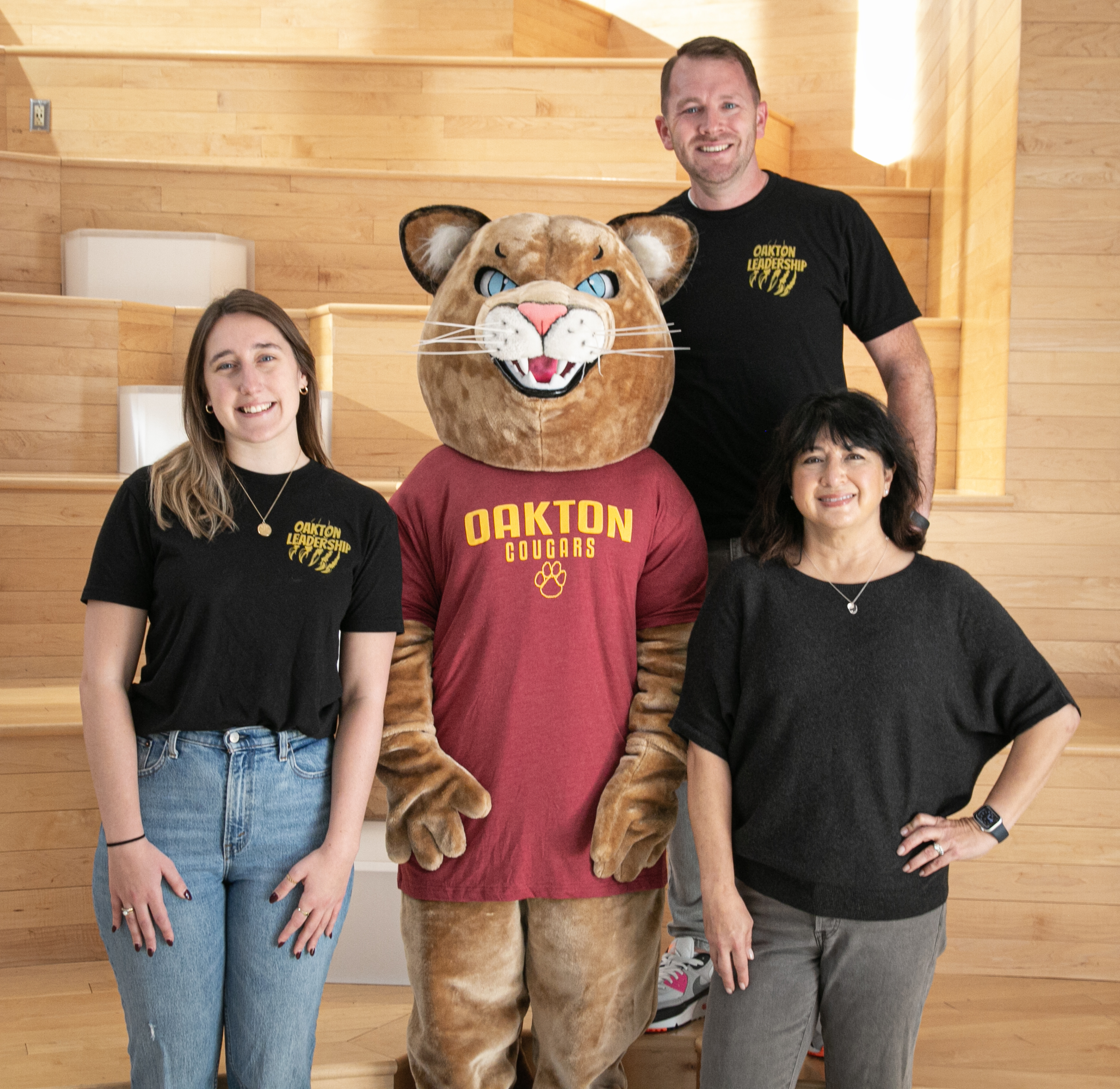 image of three leadership teachers with a cougar mascot